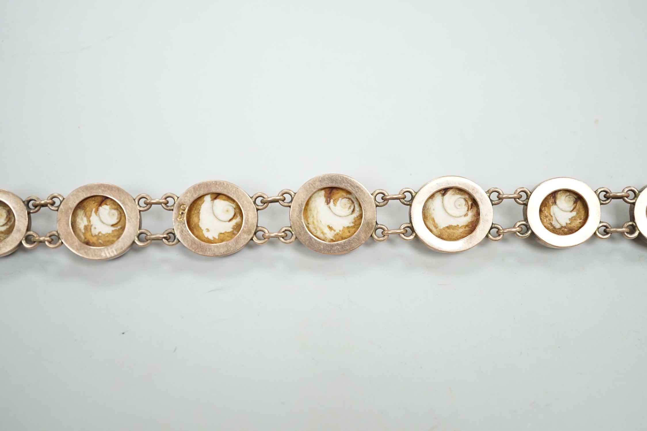 An early 20th century yellow metal and shell set bracelet (clasp shell missing), approx. 18cm, gross weight 26.8 grams.